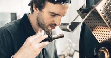 Coffee roaster assessing aroma during roasting to maintain consistency across multiple origins and green coffee lots