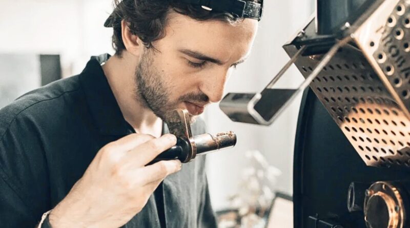 Coffee roaster assessing aroma during roasting to maintain consistency across multiple origins and green coffee lots