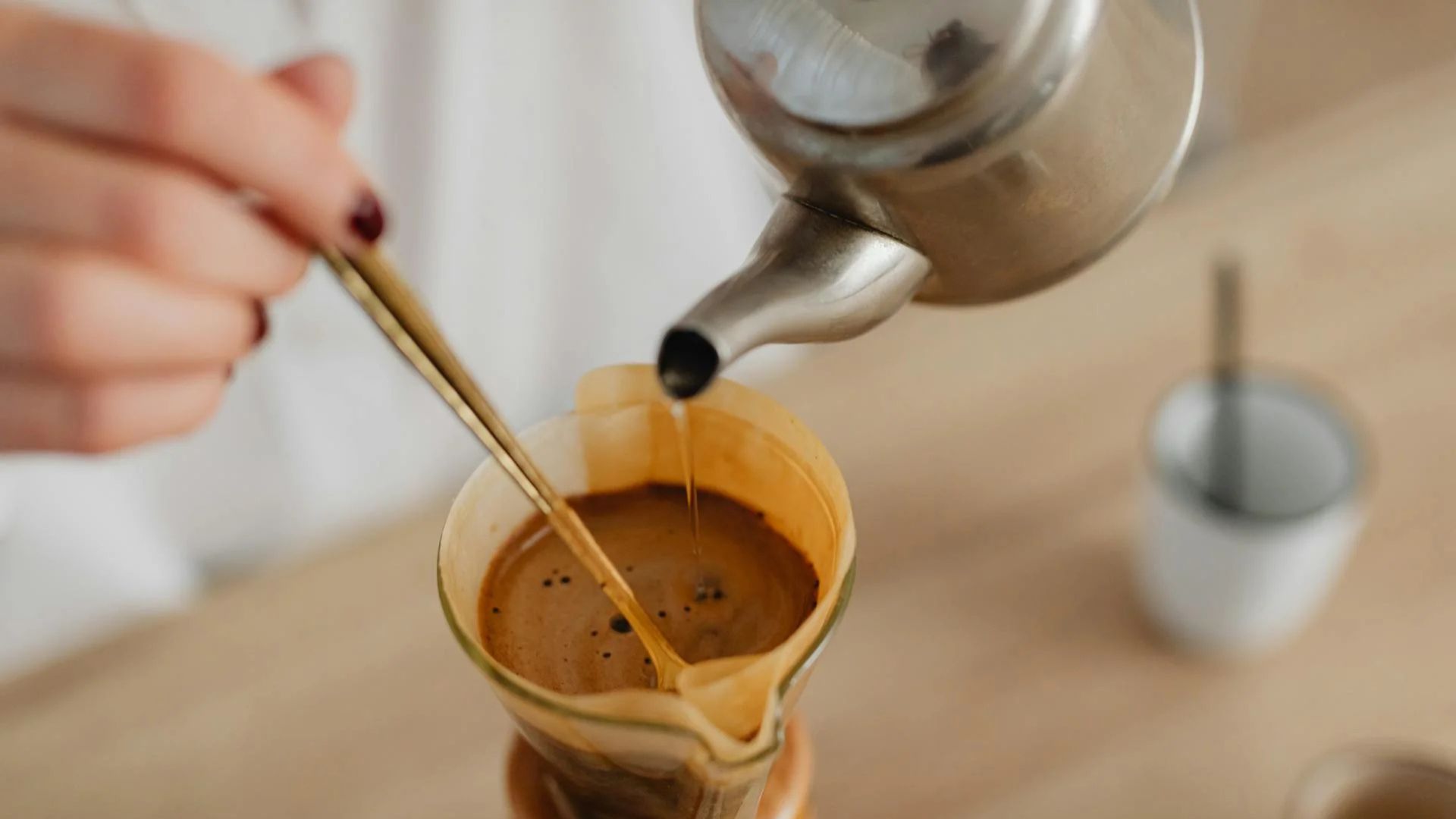 Hand brewing pour-over coffee with kettle, illustrating common coffee brewing mistakes that ruin flavor