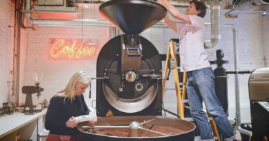 Coffee roastery team operating a commercial roasting machine, illustrating the shift from craft roasting to scalable production systems