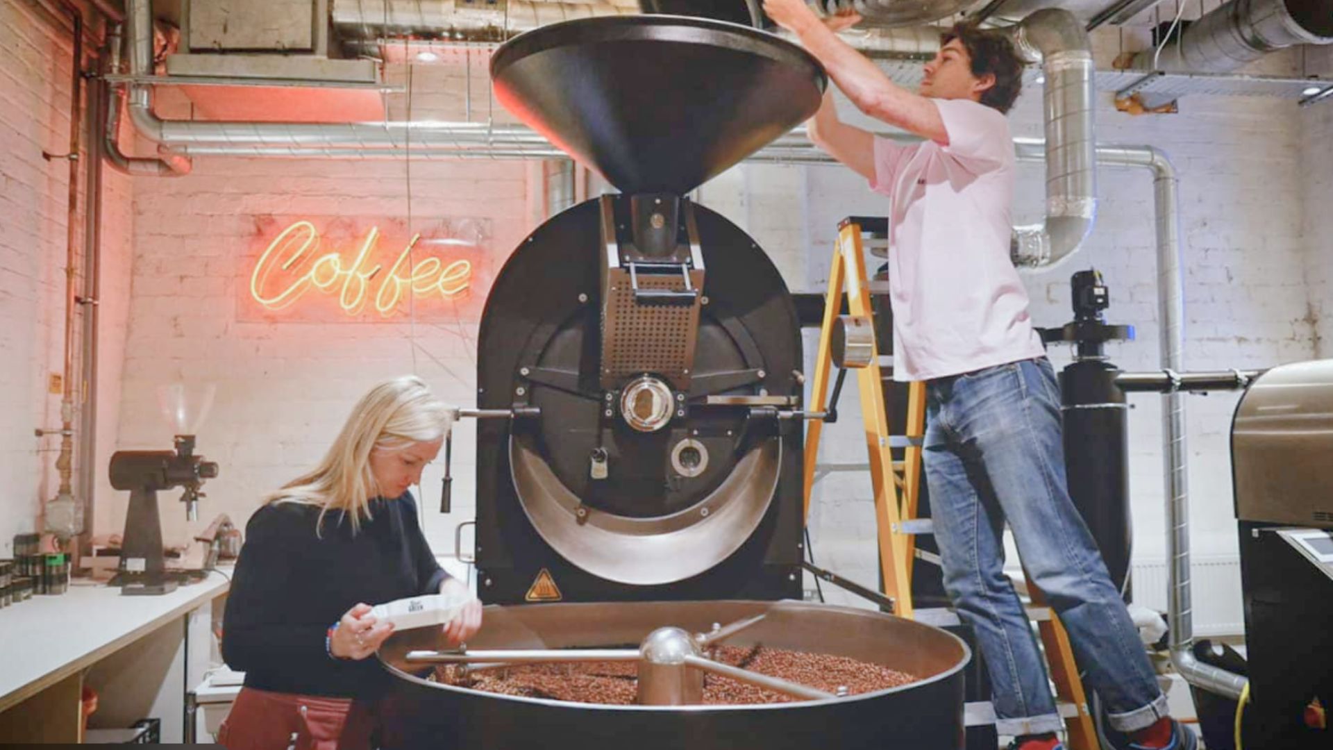 Coffee roastery team operating a commercial roasting machine, illustrating the shift from craft roasting to scalable production systems