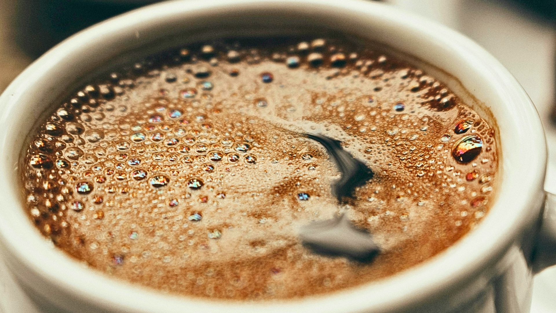 Close-up of brewed coffee highlighting caffeine’s role in daily consumption