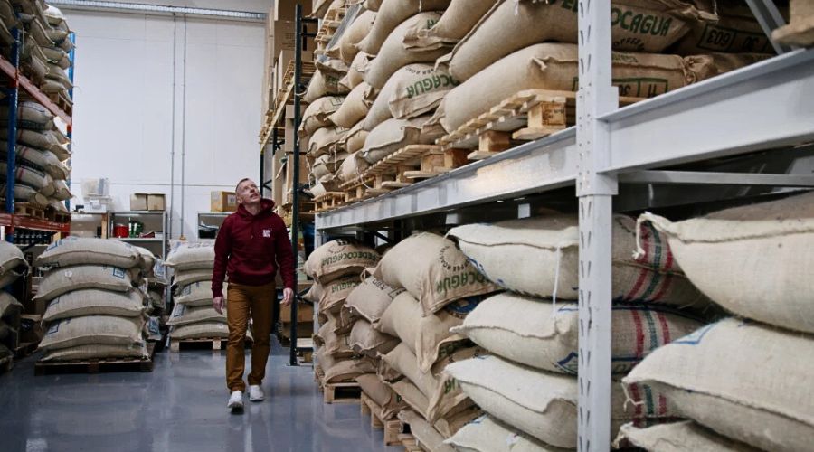 Green coffee inventory in warehouse illustrating roastery cash flow and budgeting decisions for 2026 