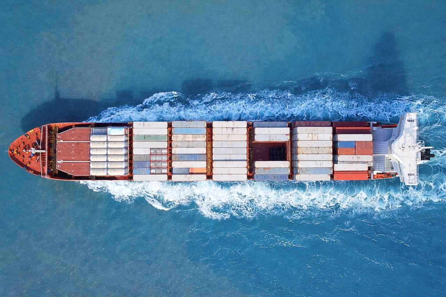 Container ship transporting goods across the ocean, illustrating how value and risk move through the global coffee trade