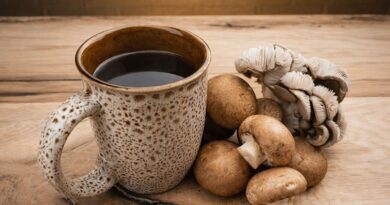 A cup of mushroom coffee placed next to medicinal mushrooms, illustrating the growing functional beverage trend