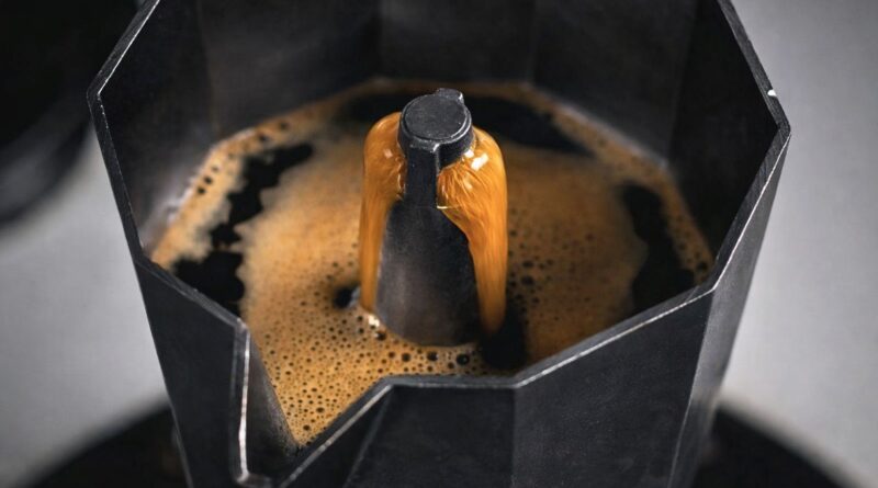 Coffee extracting smoothly from a moka pot with controlled heat to reduce bitterness and improve flavor balance