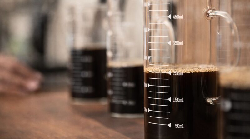 Cold brew coffee brewed with controlled extraction using precise coffee-to-water ratios in a glass measuring vessel