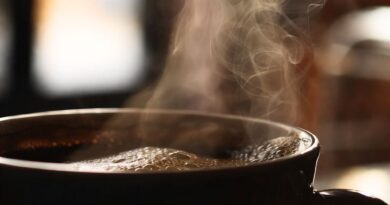 Steaming cup of hot coffee illustrating how coffee consumption stimulates digestion and bowel movements through gut and nervous system activation