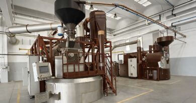 Large-scale coffee roasting facility illustrating the operational and cost pressures roasteries face when balancing budget discipline with coffee quality