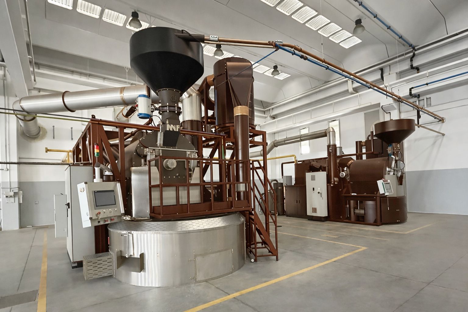 Large-scale coffee roasting facility illustrating the operational and cost pressures roasteries face when balancing budget discipline with coffee quality
